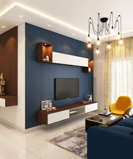 image of the inside of a lounge room. Showing a tv on a blue walk with some shelves. A modren light fixture and a few chairs